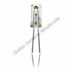A pair of long kitchen tongs or turners in clear plastic wrapping with a printed cardboard header card, placed on a concrete floor.