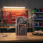 A 16-piece hammer and bit set in a clear plastic case, standing on a wooden workbench in a workshop. The background shows a blurred red tool rack with hanging tools and shelves with storage bins.