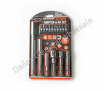 A 16-piece adapter and bit set in retail blister packaging, photographed on a gray concrete floor. The set includes multiple socket adapters and bit nozzles in dark metallic gray with red and black packaging accents.