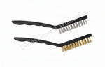 Two black brushes with bristles on a concrete surface