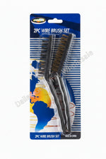 Two wire brushes on a colorful packaging with visible brand logo on a concrete surface.