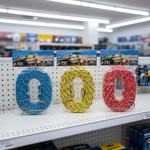 Three packages of 1-72 scale rubber stretch cords in blue, yellow, and red, displayed on a white retail store shelf.