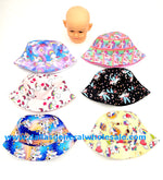 Assortment of little girls' unicorn-themed bucket hats in various colors with a plastic mannequin head.