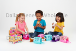 Three children sitting on a white studio floor playing with colorful plush animal toys and small plastic pet carriers. A large semi-transparent 'Dallas General Wholesale' watermark is visible across the background.