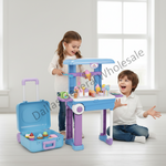 Two children playing with a toy ice cream cart and matching suitcase in a bright indoor room. The toy set includes a blue, purple, and white cart with colorful pretend ice cream cones and a matching open suitcase on the floor.