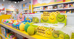 A retail display shelf featuring 'Durian Squishy' squishy toys shaped like durian fruits, with some loose toys in yellow and green spiky textures and boxed toys in the background.