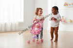 Two young children playing in a bright room with a pink toy stroller. One child pushes the stroller containing a doll, while the other stands beside them holding a small pink toy.