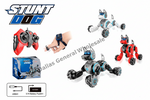 Stunt Dog wireless remote control toy dog set, featuring a black and gray robot dog with blue accents, a red remote controller, a red and black robot dog, a blue retail box, and a wrist strap shown on a hand. Includes a USB cable and 3.