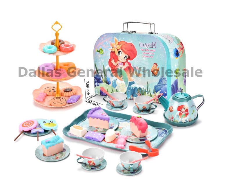 Toy tea set with a suitcase featuring a mermaid design, including a teapot, cups, and plates on a white background.
