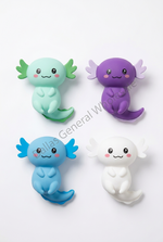 Four small cartoon axolotl figurines in mint green, purple, blue, and white, arranged on a plain white background. A diagonal watermark reading Dallas General Wholesale is visible across the center.