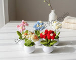 Set of colorful crocheted flower pots on a gray surface