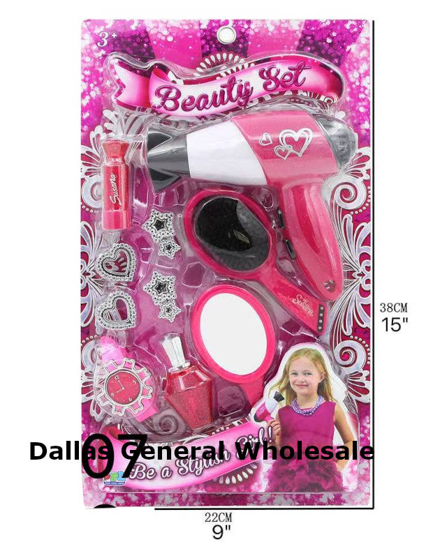 Pink toy beauty set with hair dryer, brush, and mirror in packaging on a white background.