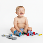 Baby sitting on a white background with colorful socks around