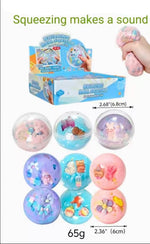 A product listing graphic for a boxed toy set of squishy ball stress toys. The image includes a hand squeezing one of the pink balls, a blue display box, multiple colorful round balls with small animal and flower details, dimensions, weight, and text reading 'Squeezing makes a sound' and '12/box 16box/cs 192pcs'.
