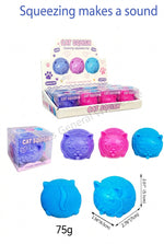 Cat squeaky toys set shown with a retail display box, a single packaged toy, and four loose toys in blue, purple, and pink on a white background. Text at the top reads 'Squeezing makes a sound' and includes quantity/weight details.
