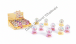 A display box filled with small pink and yellow snow globe toys, with several individual snow globes arranged in front on a white background. A diagonal 'Dallas General Wholesale' watermark is visible across the photo.