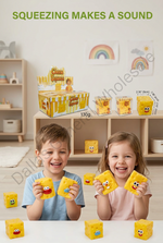Two children smiling and holding yellow cheese-shaped toy blocks with cartoon faces in a bright playroom. The scene includes a display box, smaller toy containers, and the text 'SQUEEZING MAKES A SOUND' at the top, with a visible 'Dali Wholesale' watermark across the image.