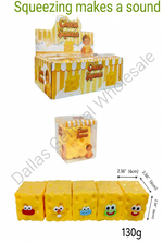 A product listing graphic for 'Cheese Squeezies' showing a 6-pack display box, a single packaged unit, and five loose yellow cheese-shaped squishies with cartoon faces. Text overlays specify quantity as 96 pieces/box and include dimensions and weight.
