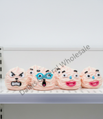 Five novelty poop-shaped squishies with different cartoon faces are lined up on a white shelf. The designs include an angry face, glasses, shock, tears of joy, and tears of sadness.