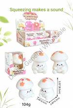 Mushroom-shaped squishy toy shown in a retail display box and as several individual figures, with dimensions and weight text on a white background with decorative green leaves.