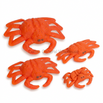 Four bright orange crab figurines in different sizes on a plain white background, with a faint Dallas General Wholesale watermark across the center.