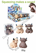 A product collage showing squeeze toy yak figurines in multiple colors, including a retail display box, a hand squeezing one toy, three individual toy yak figures, and dimension/weight text. The text reads '12/box, 12box/cs, 144/cs' and '1540-60NJM/144PCS Squeezing makes a sound'.