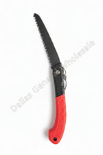 Folding saw with red handle on a concrete surface
