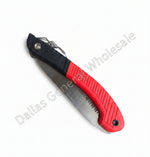 Folding saw with red handle and black blade on a concrete surface