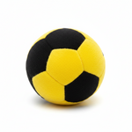A classic black and yellow soccer ball made of textured plush or faux fur, photographed on a clean white background with a soft shadow underneath.