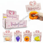 Pinkfong house packaging with small toys and a hand holding an orange toy.