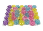 Colorful gelatinous toys in clear packages with a pink box featuring cartoon characters in the background.