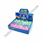 A retail display box of colorful squeeze dough toys, with hands holding a pink and a green toy in front of the box. The packaging reads 'GAME Controller SQUEEZIEZ DOUGH TOY' and shows multiple pastel-colored, soft squeezable toys inside clear plastic wrapping.