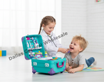 A toddler girl in a white doctor coat uses a stethoscope and plays with a turquoise toy medical suitcase filled with toy instruments, while a young boy lies on a colorful mat nearby in a bright room. A diagonal 'Dallas General Wholesale' watermark is visible across the photo.