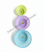 Three colorful plastic bowls stacked on a white background