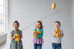 Three children standing in a studio holding yellow squishy toys, with more yellow squishys hanging from the ceiling and a large watermark reading 'Allas General Wholesale' across the center.