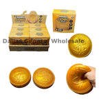 Jumbo Coin Squeaker toy set in gold-colored packaging, showing a retail display box, individual boxes, two round squeeze coins, and a hand squeezing a larger coin to demonstrate the squishy texture.