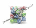 A clear plastic bag containing 12 colorful braided rope dog toys, including red and white, blue and white, and green and white knotted ropes, placed on a concrete floor.