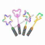 Four novelty plastic wand-shaped items with colorful neon rainbow outlines and striped handles, arranged on a plain white background with a diagonal 'Dallas General Wholesale' watermark across the center.