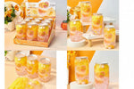 A collage showing a boxed display of mango-flavored drink cans and several individual cans on styled tabletops. The cans contain layered pink and yellow drink with fruit pieces.