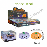 Pumpkin-shaped coconut oil candles in a Halloween-themed display box, with two small sample candles shown in front and text indicating 12 boxes, 144 pieces, coconut oil, and dimensions.