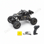 A black remote control off-road truck with large knobby tires, shown with its matching black remote control, a yellow battery, and a small yellow case on a white background. A diagonal watermark 'Dallas Chemical Wholesale' is visible across the image.