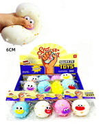 A display box and individual packs of squishy squeeze toys, with a hand demonstrating the soft, bouncy texture of one white toy. The toys have colorful cartoon faces and are shown in a retail display with text overlays indicating '5-56 144 PCS' and '6CM'.