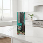 A packaged kitchen knife with a large silver blade and dark brown handle, sealed in a clear plastic blister pack with a bright teal and black backing card. The card includes product text and food imagery near the bottom.