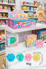 Super Squishy! jelly toy set in a toy store display, showing the retail box, individual boxes, loose translucent jelly paw-shaped toys, and a hand squeezing one of the clear jelly toys. Product size 90g and dimensions are labeled.