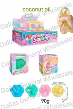 Super Squishy! coconut oil squishy toys shown in a retail display box, individual boxes, and three paw-shaped squishies in blue, teal, and yellow. A hand is shown squeezing a translucent yellow squishy.