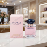 Perfume bottle and packaging labeled 'The Way for women' on a counter with a blurred interior background.