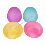 Four colorful textured balls on a light surface with a small umbrella decoration.