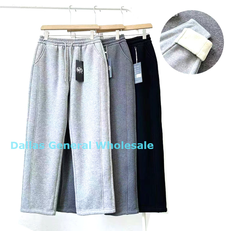 Gray and black pants on a rack with a close-up of fabric texture and 'Dallas General Wholesale' branding.