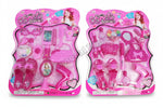 A pink and white pretend play fashion set designed for girls, including various plastic toys such as a mirror, hair clips, a toy camera, and more, packaged in a cardboard display.